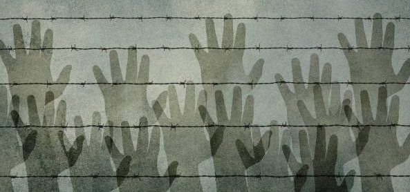 Silhouettes of hands behind a barbed wire, suggesting a refugee camp, a border crossing, or a prison.